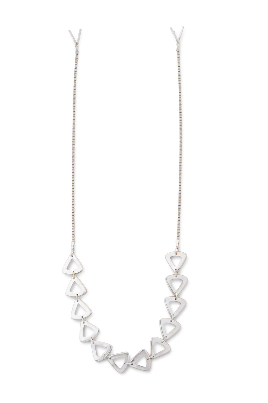Beveled broadly curved triangles drape across the chest in this demi sterling silver necklace. Handmade by Sky Phaebl.
